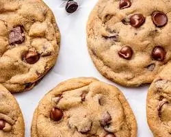 chip cookies on a cooling rack with melted chocolate chunks